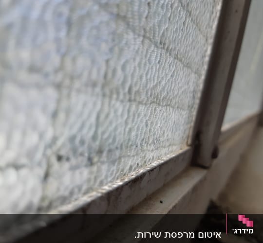 חלון עם מסגרת מתכת ואיטום זכוכית גלי